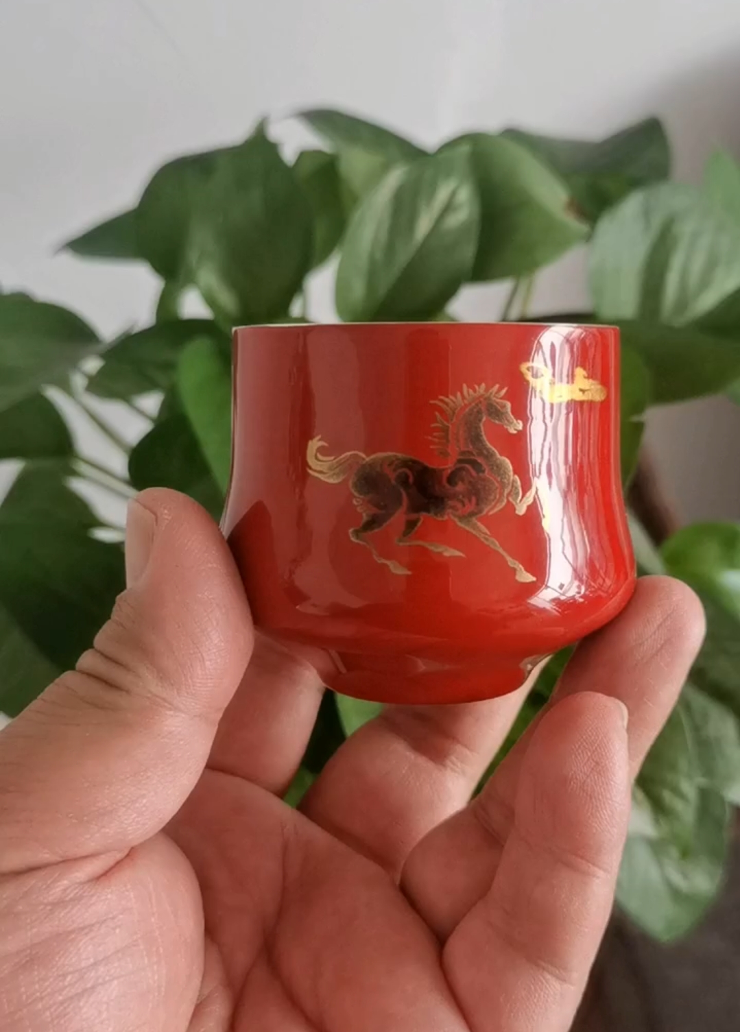 Handcrafted red teacup with gold horse motif